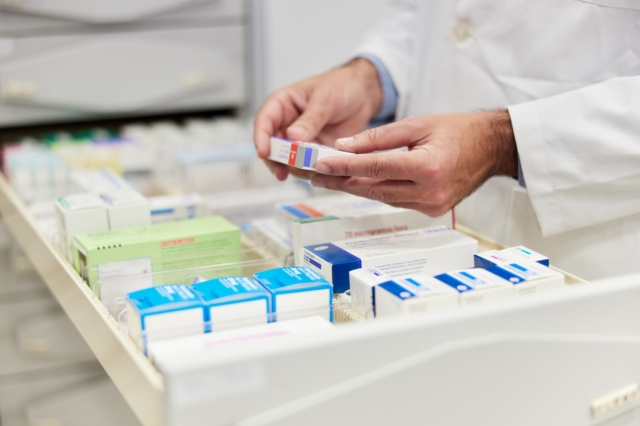 Cloe-up view of a pharmacist hands holding merchandise.